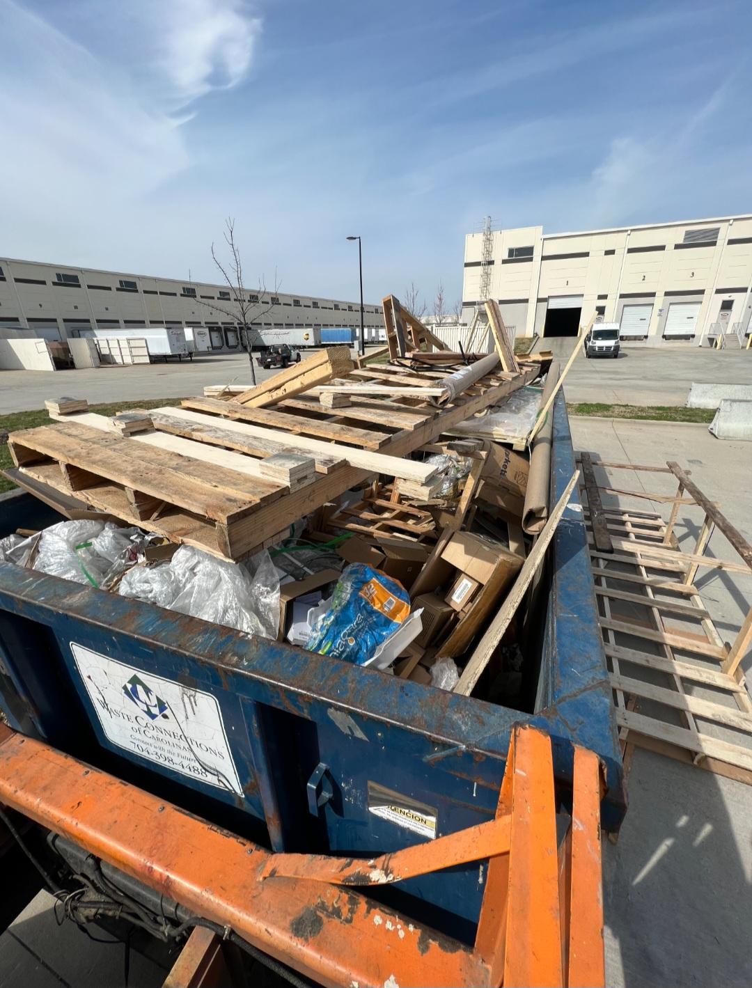 Dumpster after compaction with significantly reduced waste volume